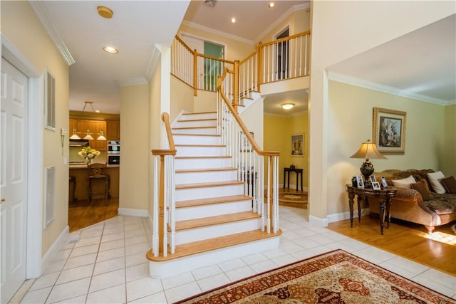 stairway featuring wood-type flooring and crown molding