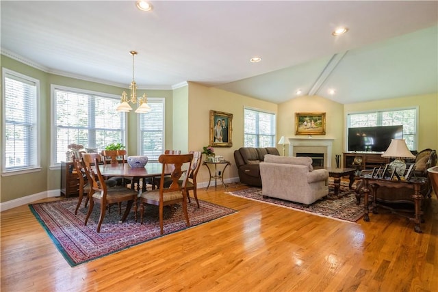 dining room with crown molding, an inviting chandelier, lofted ceiling with beams, and hardwood / wood-style flooring