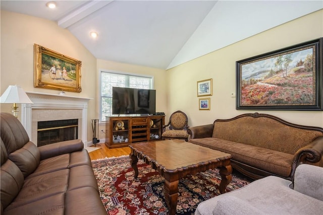 living room with vaulted ceiling with beams and hardwood / wood-style flooring