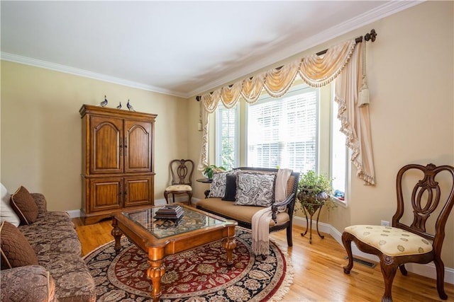 living area featuring light hardwood / wood-style floors and ornamental molding