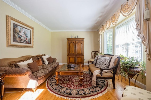 living area with light hardwood / wood-style flooring and ornamental molding