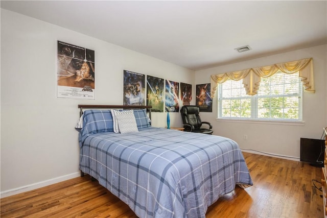 bedroom with wood-type flooring