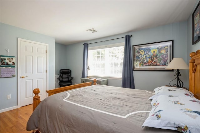 bedroom with hardwood / wood-style flooring