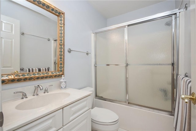 full bathroom with vanity, toilet, and enclosed tub / shower combo