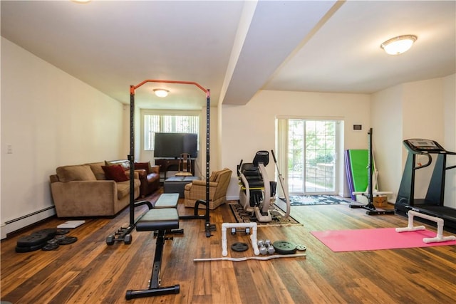 workout room featuring hardwood / wood-style floors and a baseboard radiator