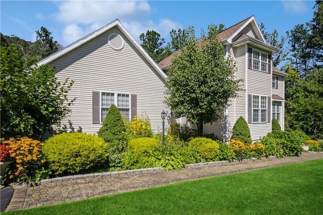 view of side of home with a lawn