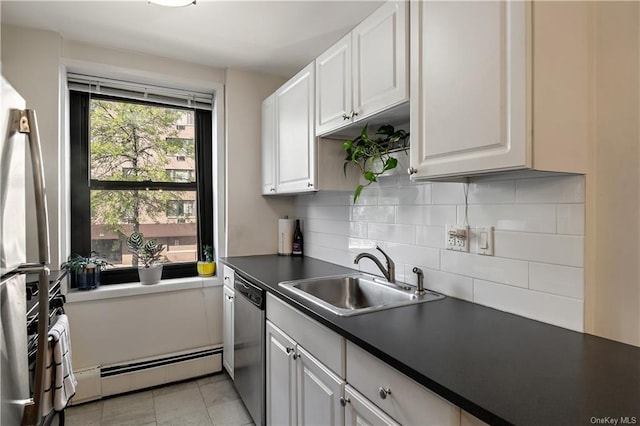 kitchen with stainless steel appliances, baseboard heating, sink, light tile patterned floors, and white cabinetry