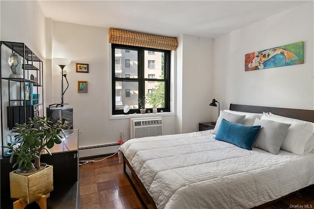 bedroom with a wall mounted air conditioner, dark hardwood / wood-style flooring, and a baseboard heating unit