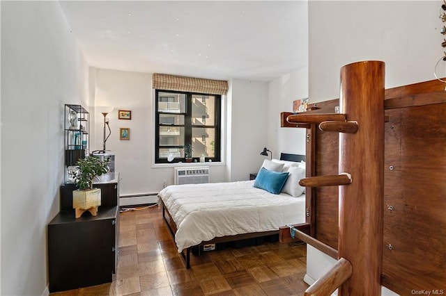 bedroom featuring dark parquet flooring, a baseboard radiator, and a wall mounted AC