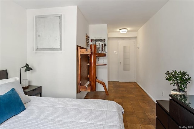 bedroom featuring dark parquet flooring