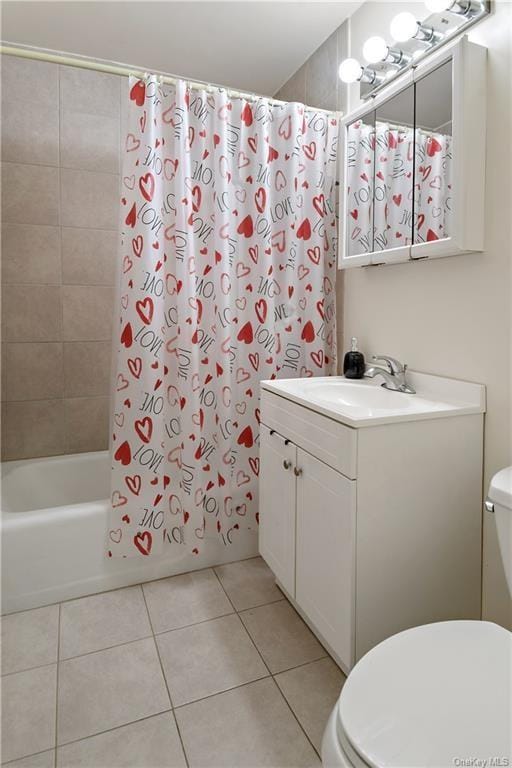 full bathroom featuring toilet, vanity, tile patterned floors, and shower / bathtub combination with curtain