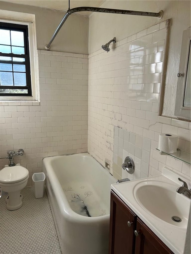 bathroom featuring tasteful backsplash, tile patterned floors, vanity, tile walls, and toilet