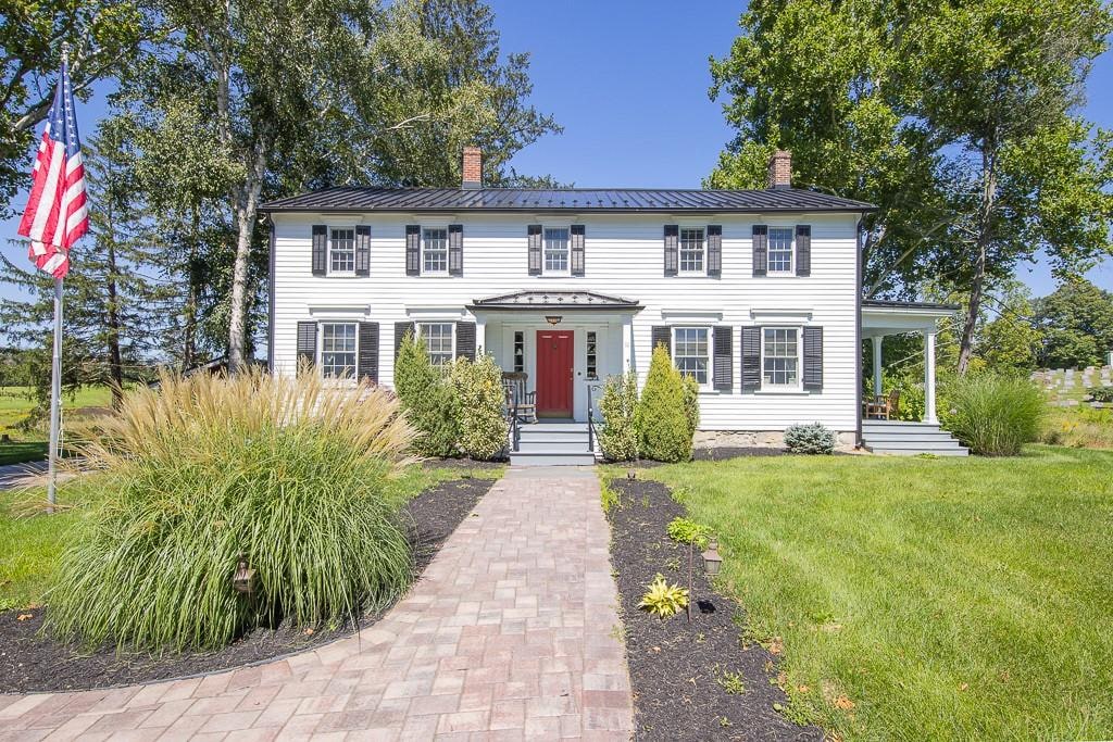 colonial inspired home with a front yard