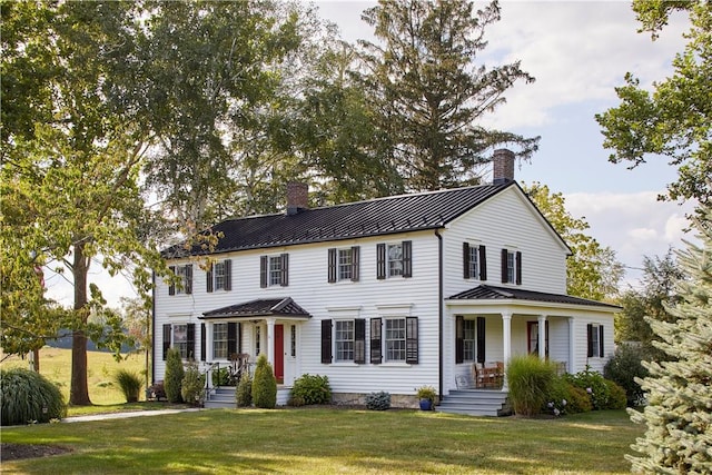 colonial-style house with a front lawn and a porch