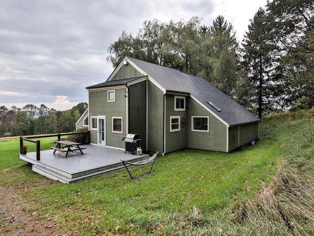 back of house featuring a yard and a wooden deck