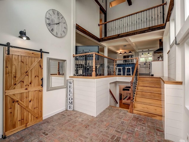 kitchen featuring kitchen peninsula and a high ceiling