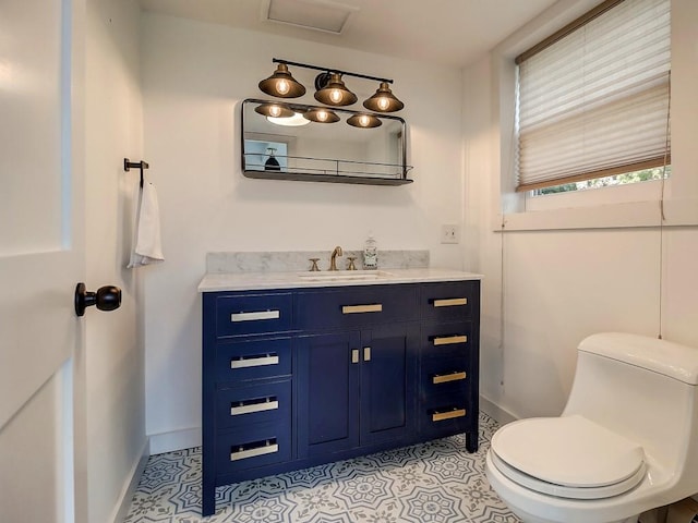 bathroom featuring tile patterned flooring, vanity, and toilet