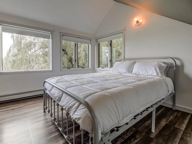 bedroom featuring hardwood / wood-style floors, lofted ceiling, and baseboard heating