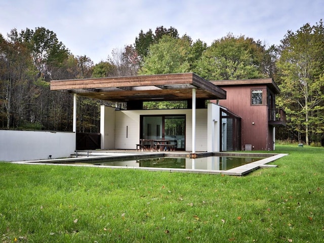 back of house with a yard and a patio