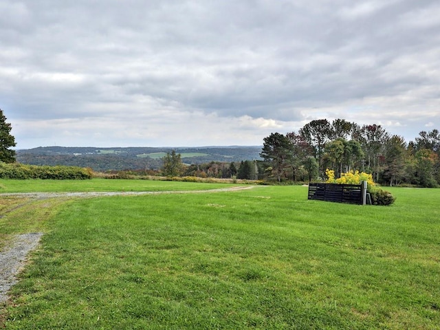 surrounding community featuring a lawn and a rural view