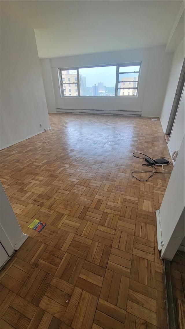 spare room featuring a wealth of natural light and light parquet flooring