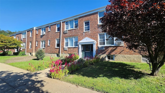 view of front facade with a front yard and brick siding