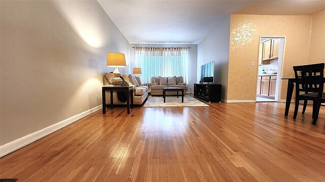 living area with wood finished floors and baseboards