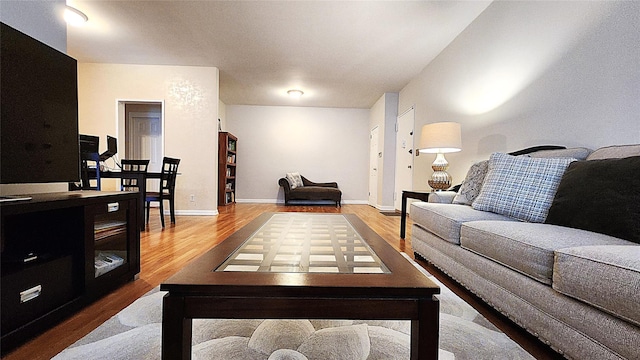 living area with wood finished floors and baseboards