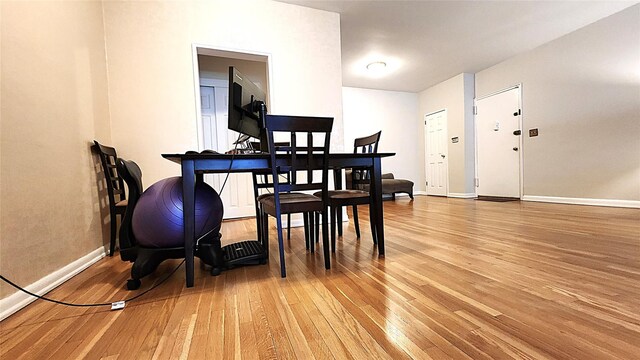 dining room featuring light wood-style flooring and baseboards