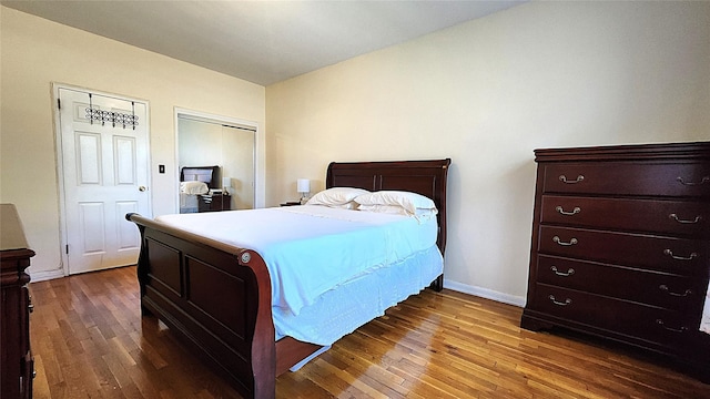 bedroom featuring hardwood / wood-style flooring and baseboards