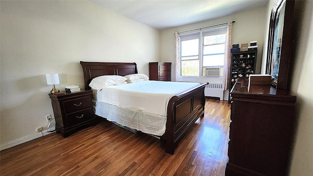 bedroom featuring radiator, dark wood-type flooring, and baseboards