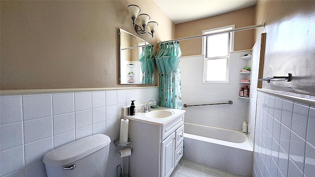 full bath with tile walls, toilet, tile patterned flooring, shower / tub combo, and vanity