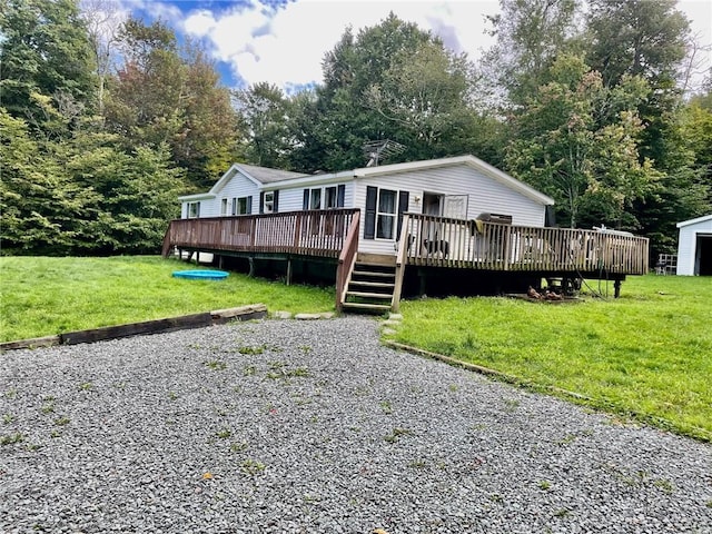 view of front facade featuring a wooden deck and a front lawn