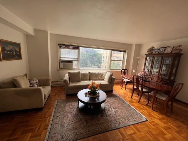 living room with cooling unit, parquet flooring, and baseboard heating