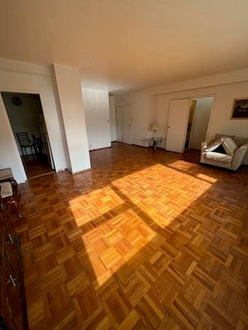 unfurnished living room with parquet flooring