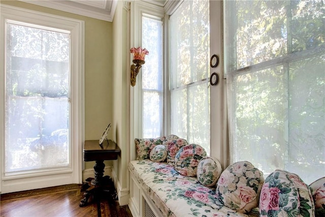 sitting room featuring dark hardwood / wood-style flooring, crown molding, and a healthy amount of sunlight