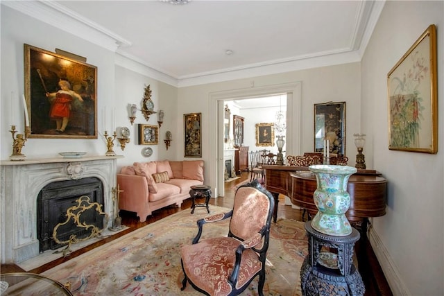 living area featuring light hardwood / wood-style floors and ornamental molding