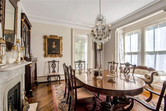 dining area featuring dark wood-type flooring, an inviting chandelier, baseboard heating, a high end fireplace, and crown molding