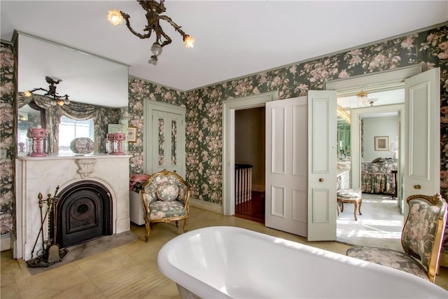 4 Deer Run, Sparkill, NY 10976 - bathroom featuring wallpapered walls, a freestanding tub, a chandelier, and a fireplace