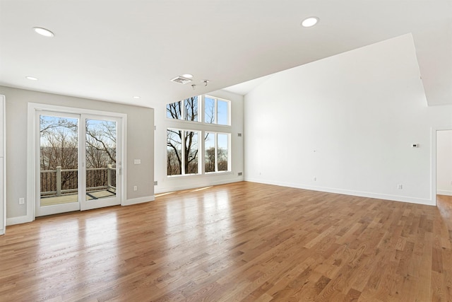 201 Tweed Blvd, Piermont, NY 10960 - unfurnished living room with light wood-type flooring, recessed lighting, and lofted ceiling