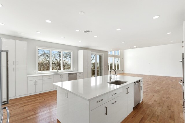 201 Tweed Blvd, Piermont, NY 10960 - kitchen with stainless steel dishwasher, light wood finished floors, light countertops, and recessed lighting