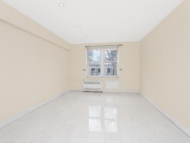 unfurnished room featuring marble finish floor, radiator heating unit, recessed lighting, and baseboards