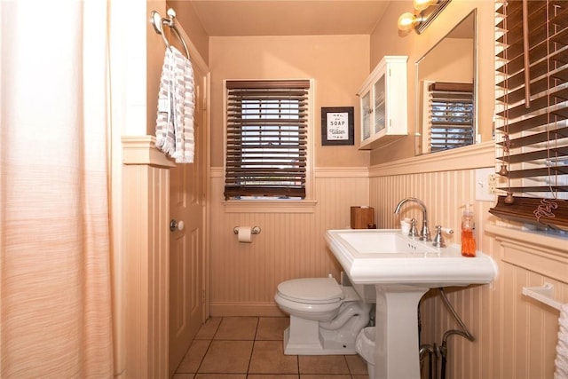 bathroom featuring tile patterned floors, toilet, and sink