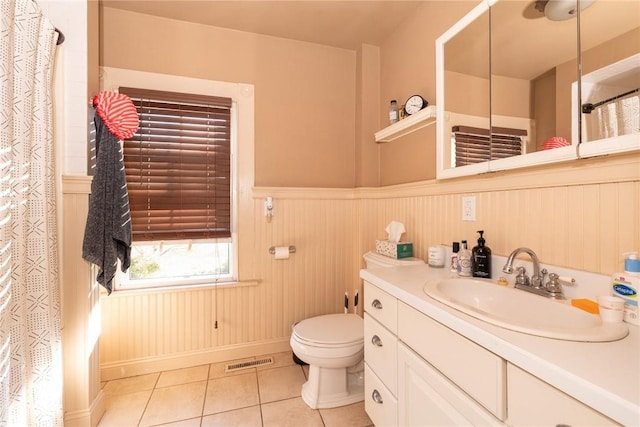 bathroom with tile patterned flooring, vanity, and toilet