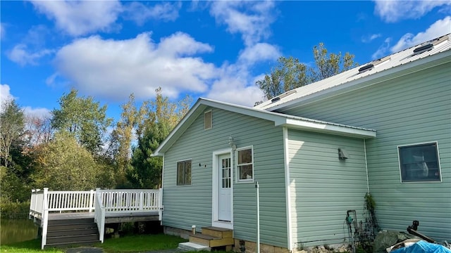 view of side of home with a wooden deck