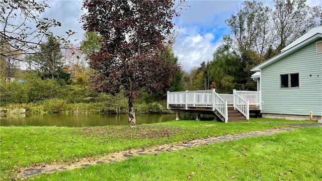 view of yard featuring a deck with water view