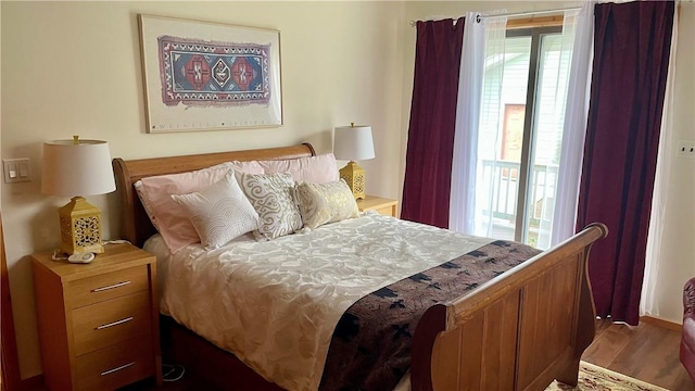 bedroom with dark hardwood / wood-style floors