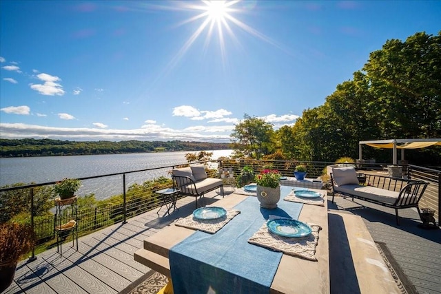 deck with an outdoor hangout area and a water view