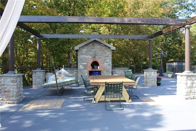 view of patio featuring a pergola and an outdoor fireplace