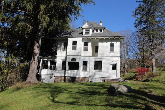 rear view of house with a yard